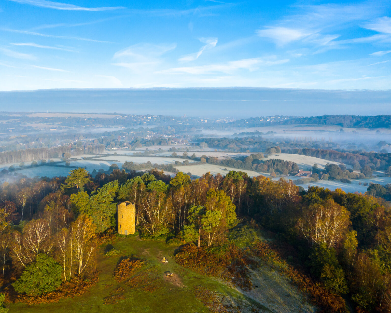 Aerial view of Chinthurst Hill with a wide landscape backdrop