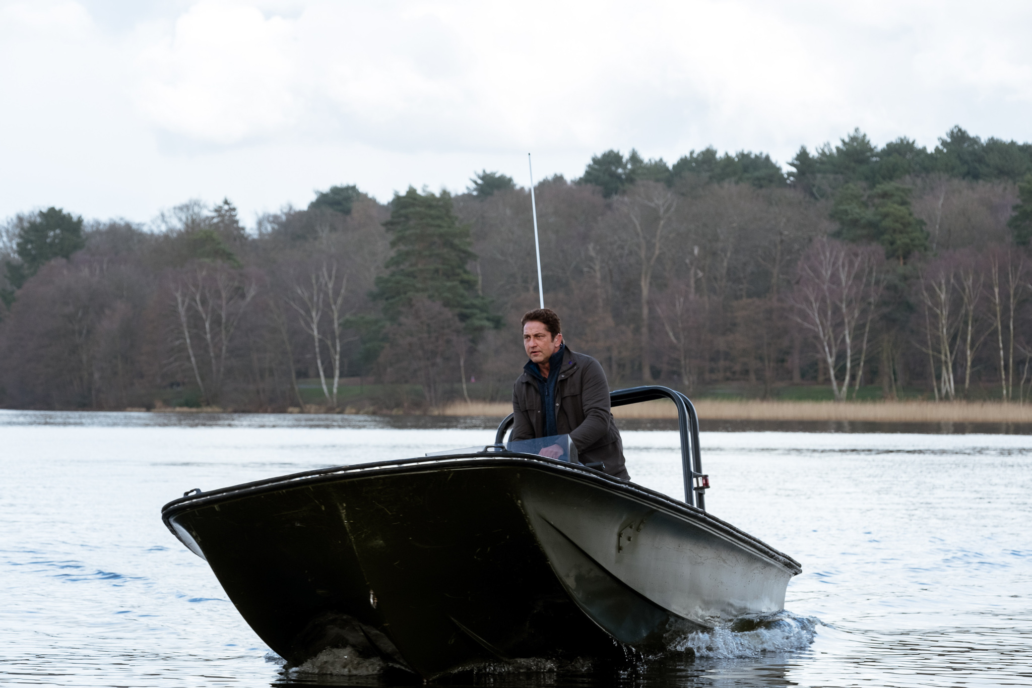 Action shot of Gerard Butler as Mike Banning, driving a speed boat on Virginia Water Lake, for Angel Has Fallen