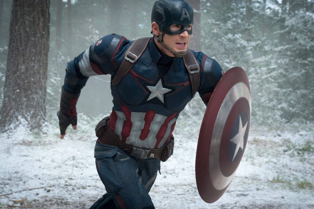 Action shot of Chris Evans as Captain America in The Avengers, running through the woods